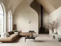 Salon moderne avec un canapé en cuir marron, une cheminée noire et un **plafond cathédrale moderne** aux arches élancées.
