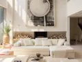 Un **salon beige et blanc** lumineux avec un grand canapé, une cheminée ornée de bois et une œuvre d'art abstraite.