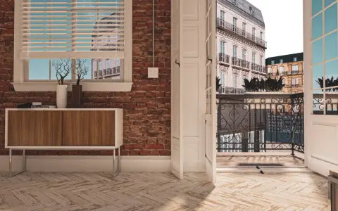 Vue d'un appartement avec une porte ouverte sur une terrasse parisienne. La différence entre balcon et terrasse est claire : ici, c'est un espace de vie extérieur spacieux.