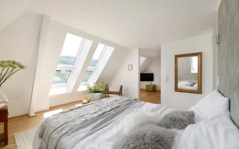 Douillette chambre mansardée avec lits douillets, fenêtres de toit lumineuses et vue sur la verdure. Un coin paisible pour se détendre.