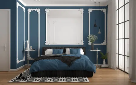 Chambre élégante avec murs bleu nuit et moulures blanches. Le lit est paré de linge de lit bleu roi, créant 2 couleurs qui vont bien ensemble pour une chambre.