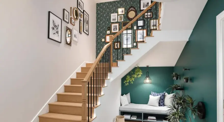 Escalier moderne avec mur de cadres et papier peint graphique. Une banquette confortable sous l'escalier, une belle idee couleur cage escalier.